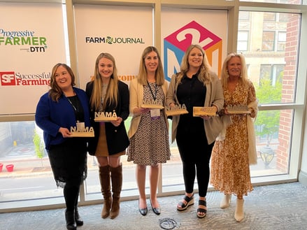 Five women holding awards